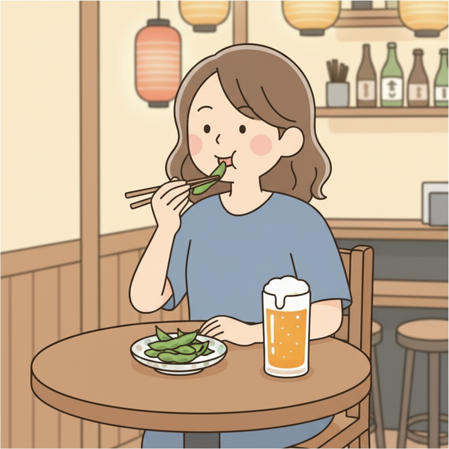 居酒屋のテーブルでお通しの枝豆を箸で楽しそうに食べている人